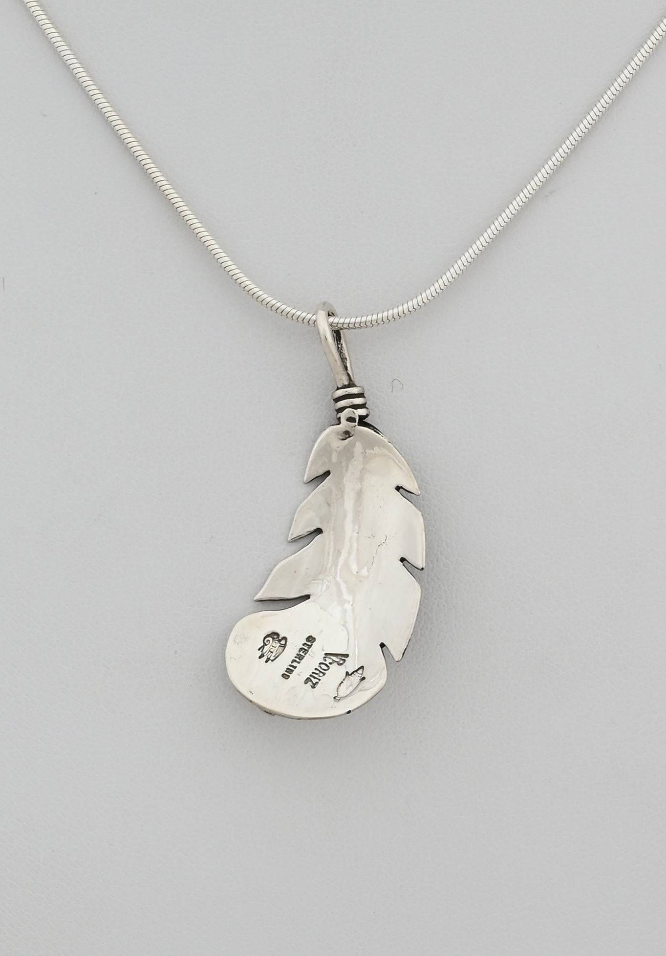 Pendant with Curved Feather by Raymond Coriz