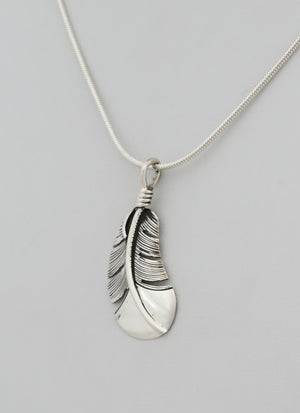 Pendant with Small Curved Feather by Raymond Coriz