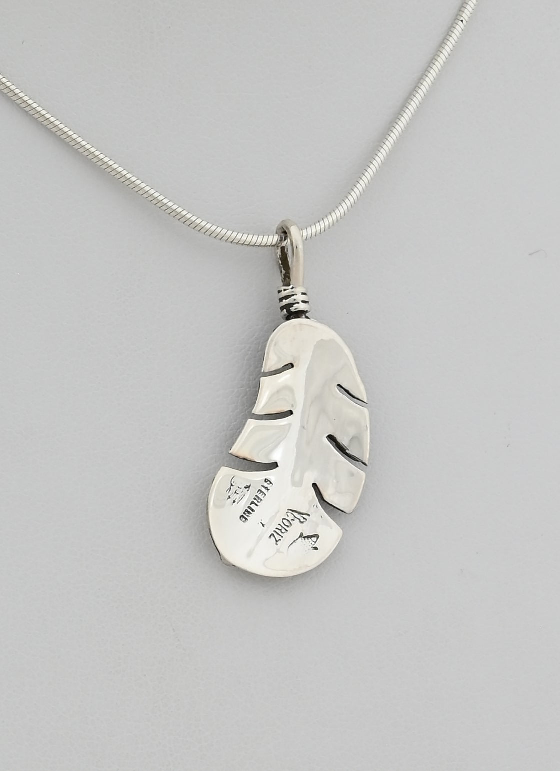 Pendant with Small Curved Feather by Raymond Coriz