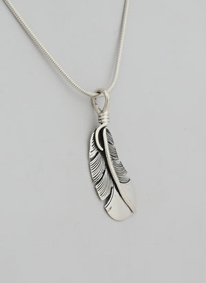 Pendant with Small Curved Feather by Raymond Coriz