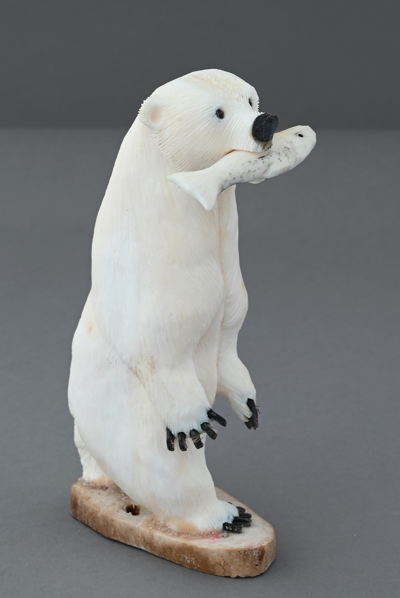 Standing Polar Bear with Fish by James Aningayou