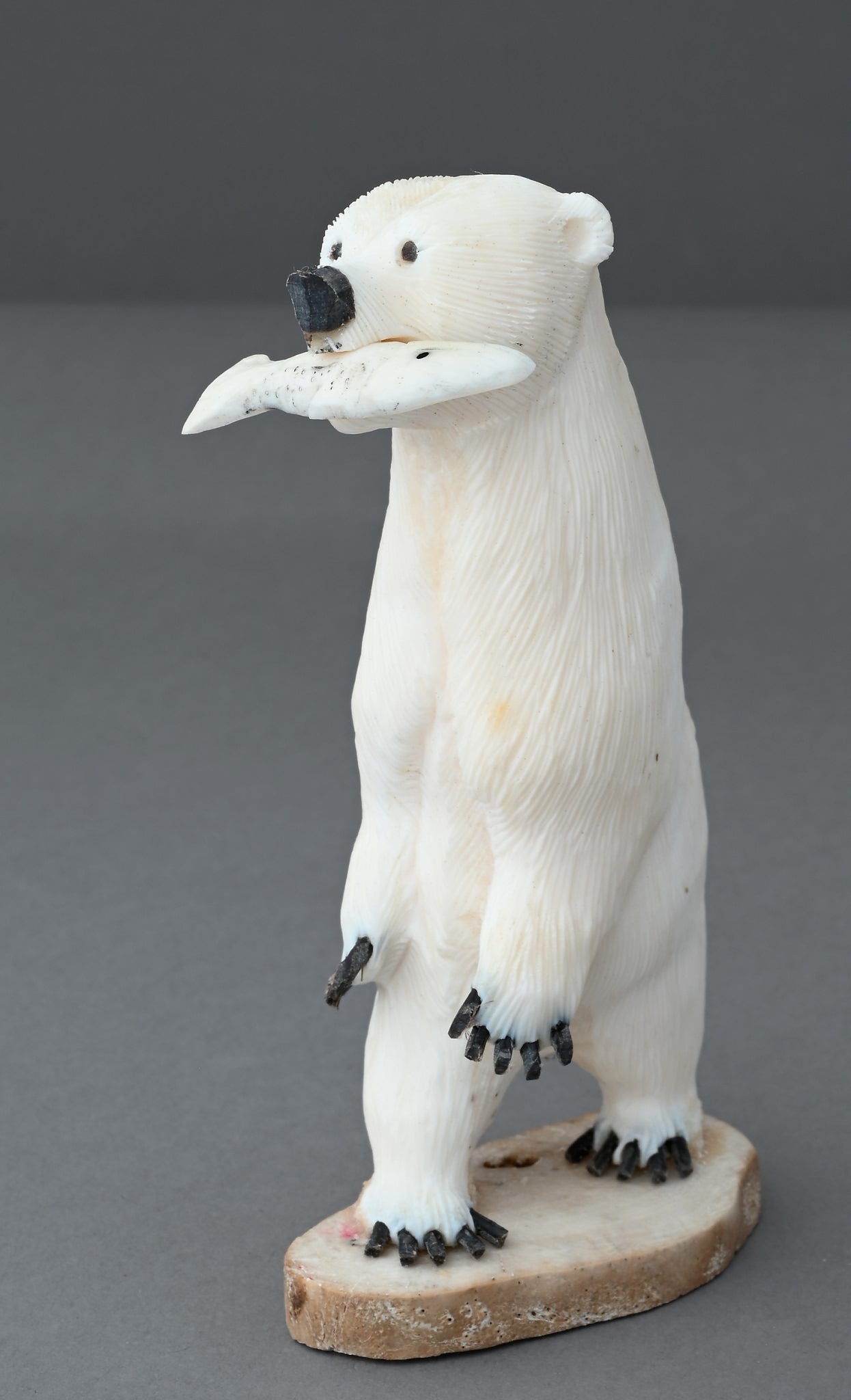 Standing Polar Bear with Fish by James Aningayou