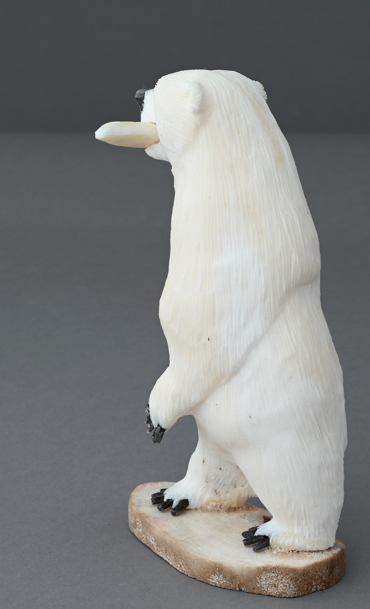 Standing Polar Bear with Fish by James Aningayou