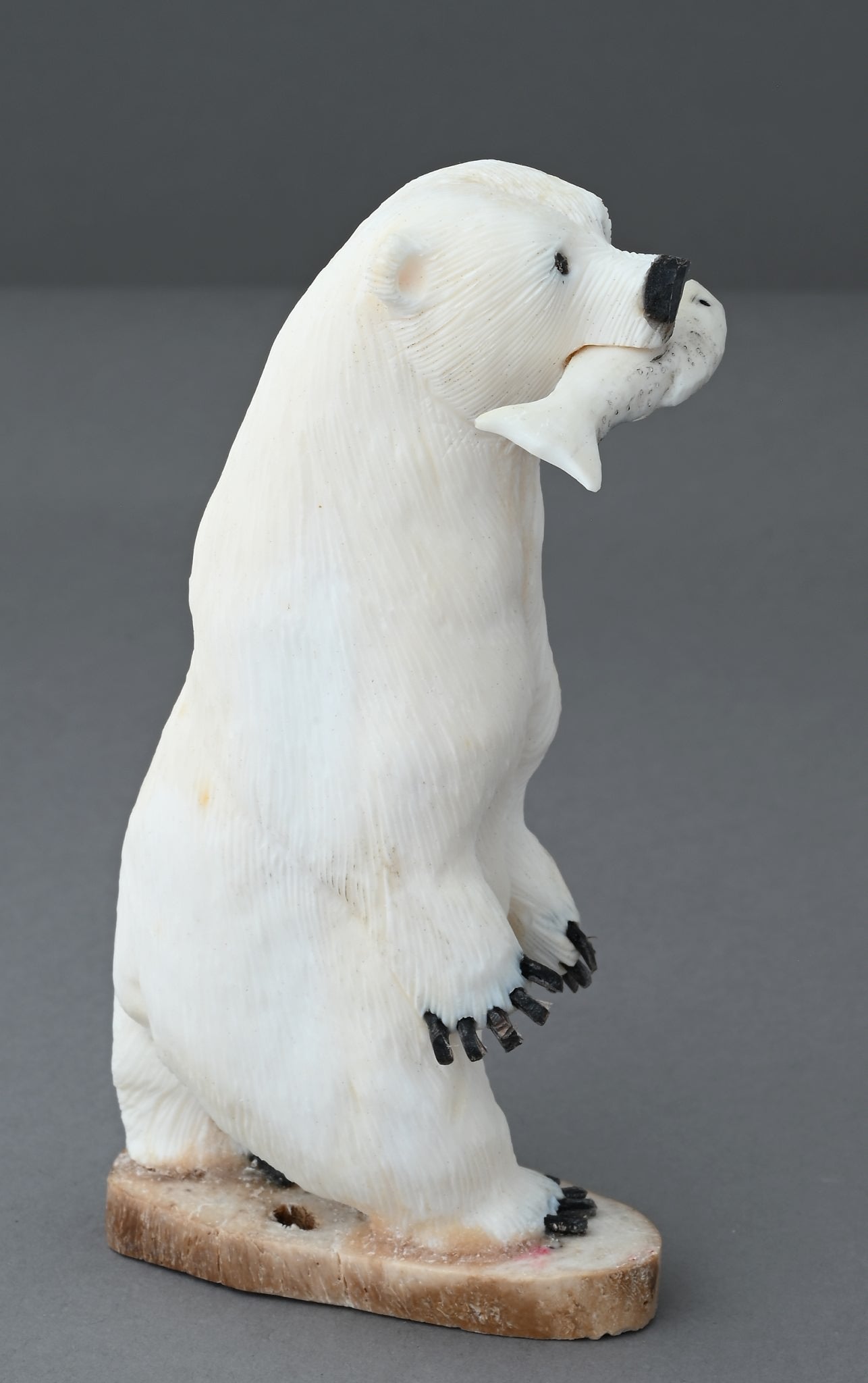 Standing Polar Bear with Fish by James Aningayou